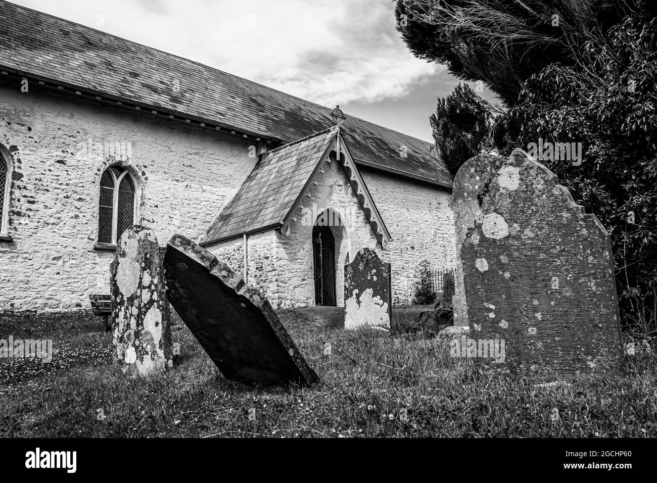 St. Cynog Churchyard in Defynnog, Powys, Wales, United Kingdom. Graveyard at a church in Black and white Stock Photo