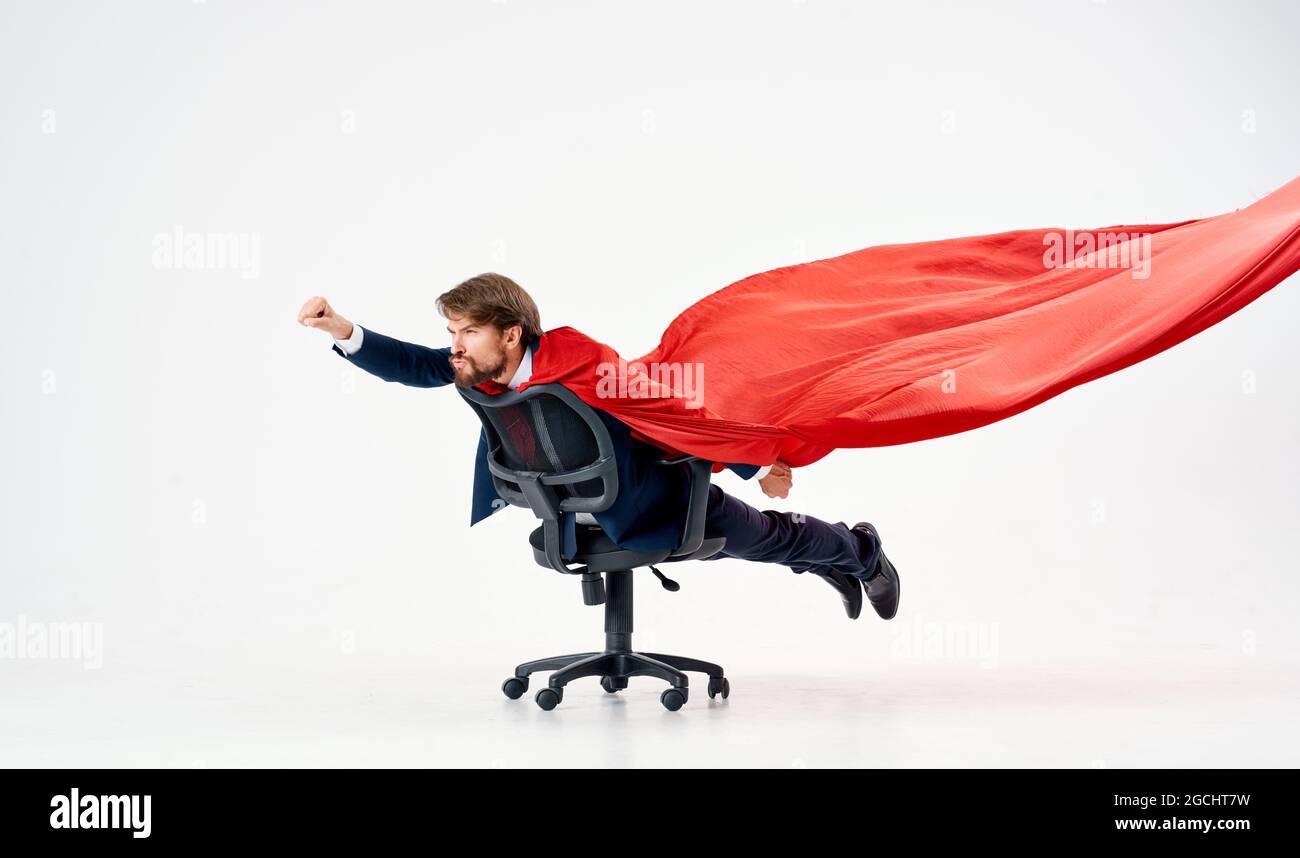 business man with red cloak in the chair hero superman Stock Photo - Alamy