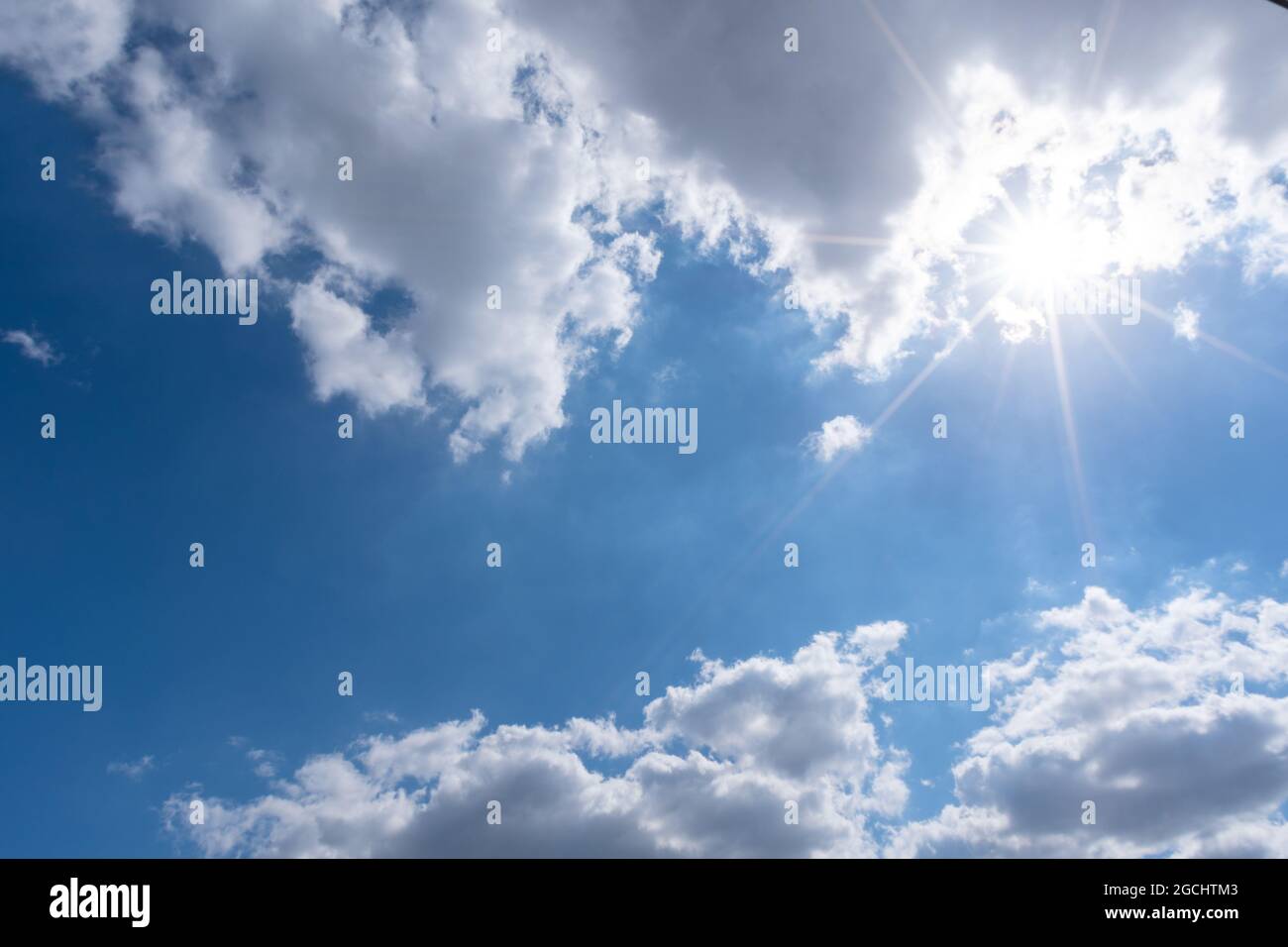 Beautiful cumulus fluffy white clouds on a blue sky with bright sun ...