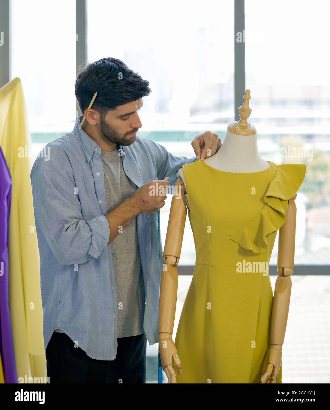 A Dressmakers Mannequin With A Yellow Tape Measure Stock Photo