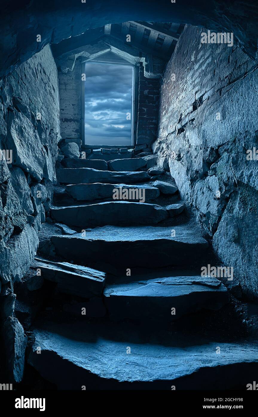 Dark steep stone stairs to cellar dungeon Stock Photo