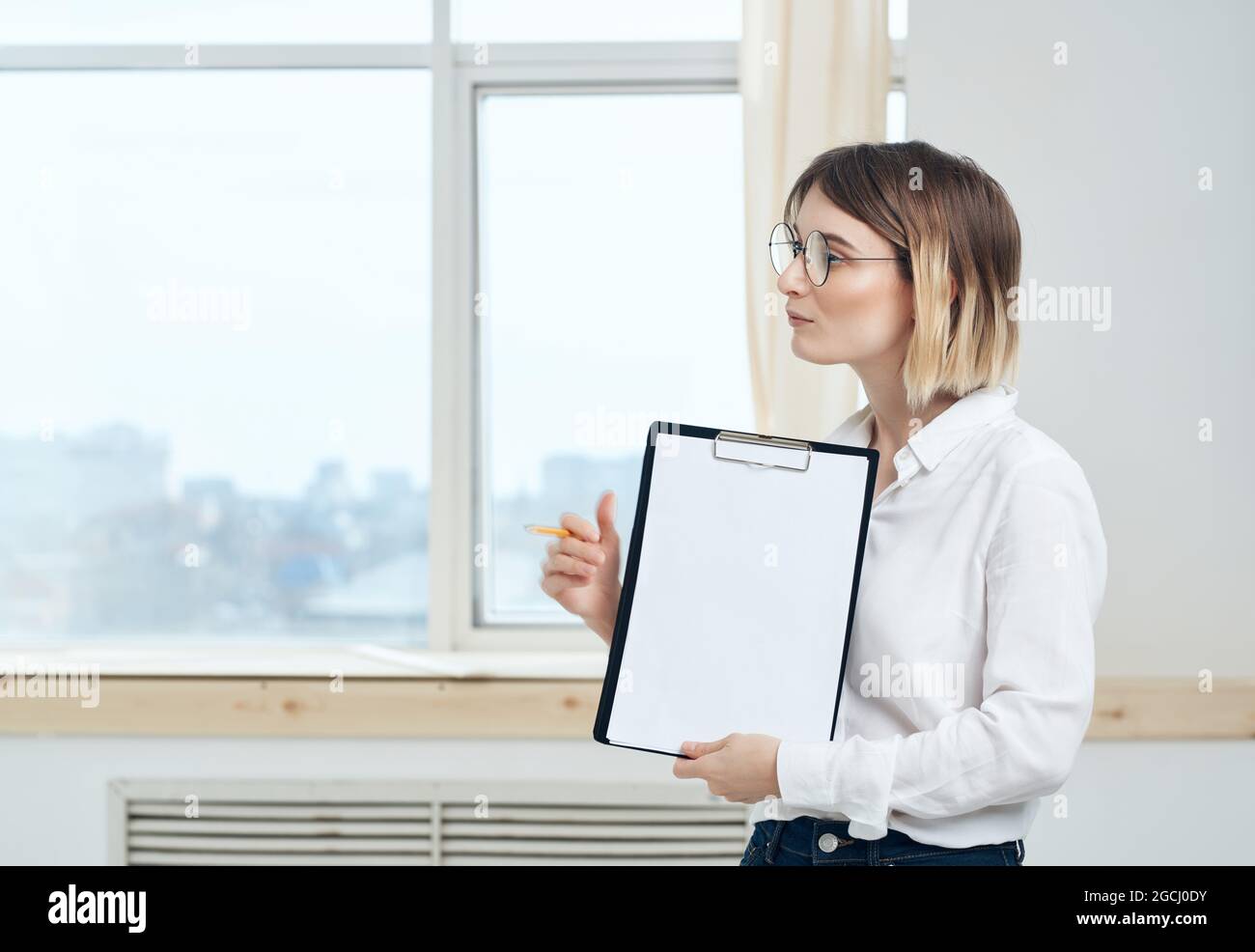 Business woman in white shirt documents office Stock Photo - Alamy