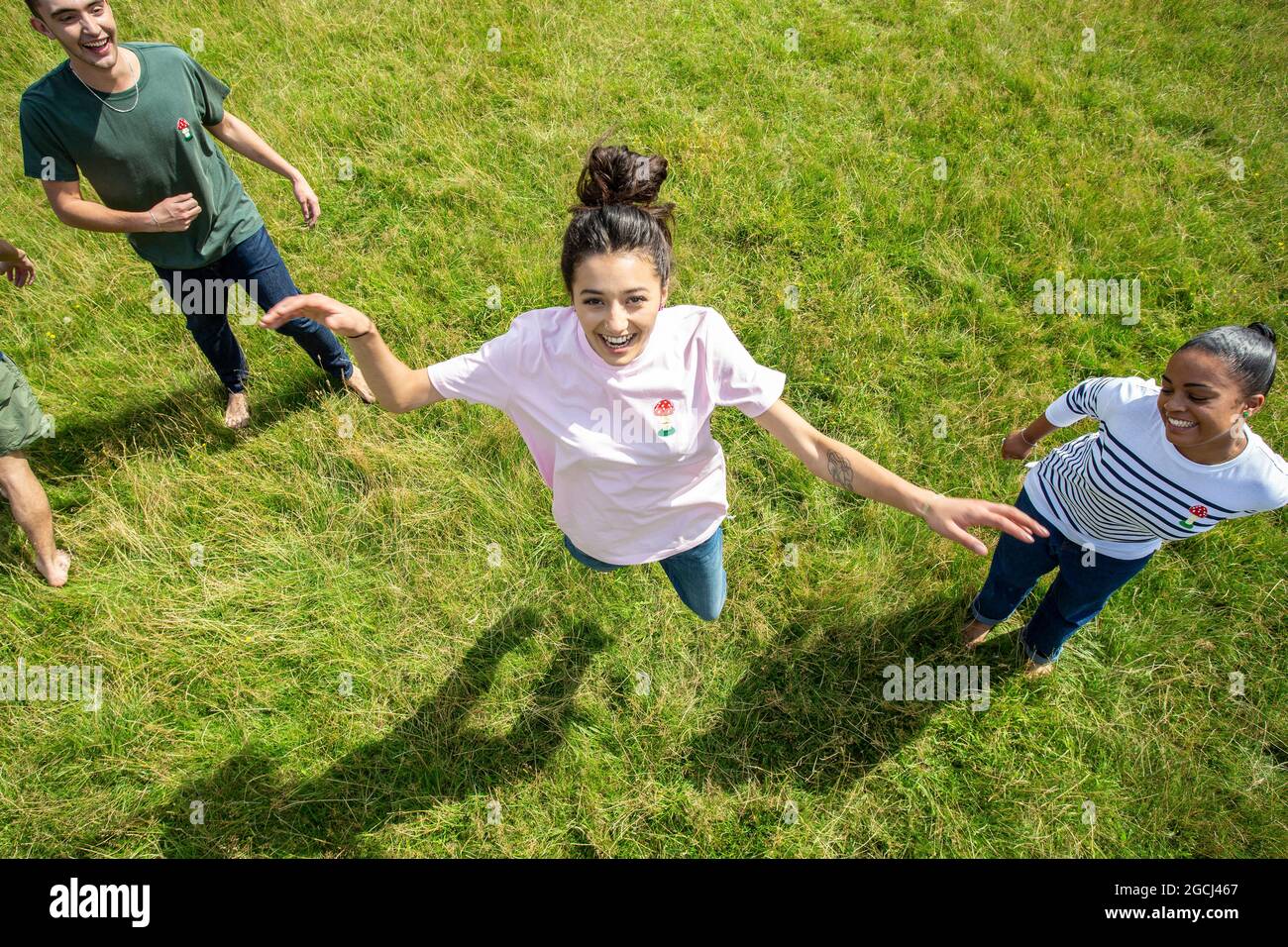 Young people jumping and looking at camera Stock Photo