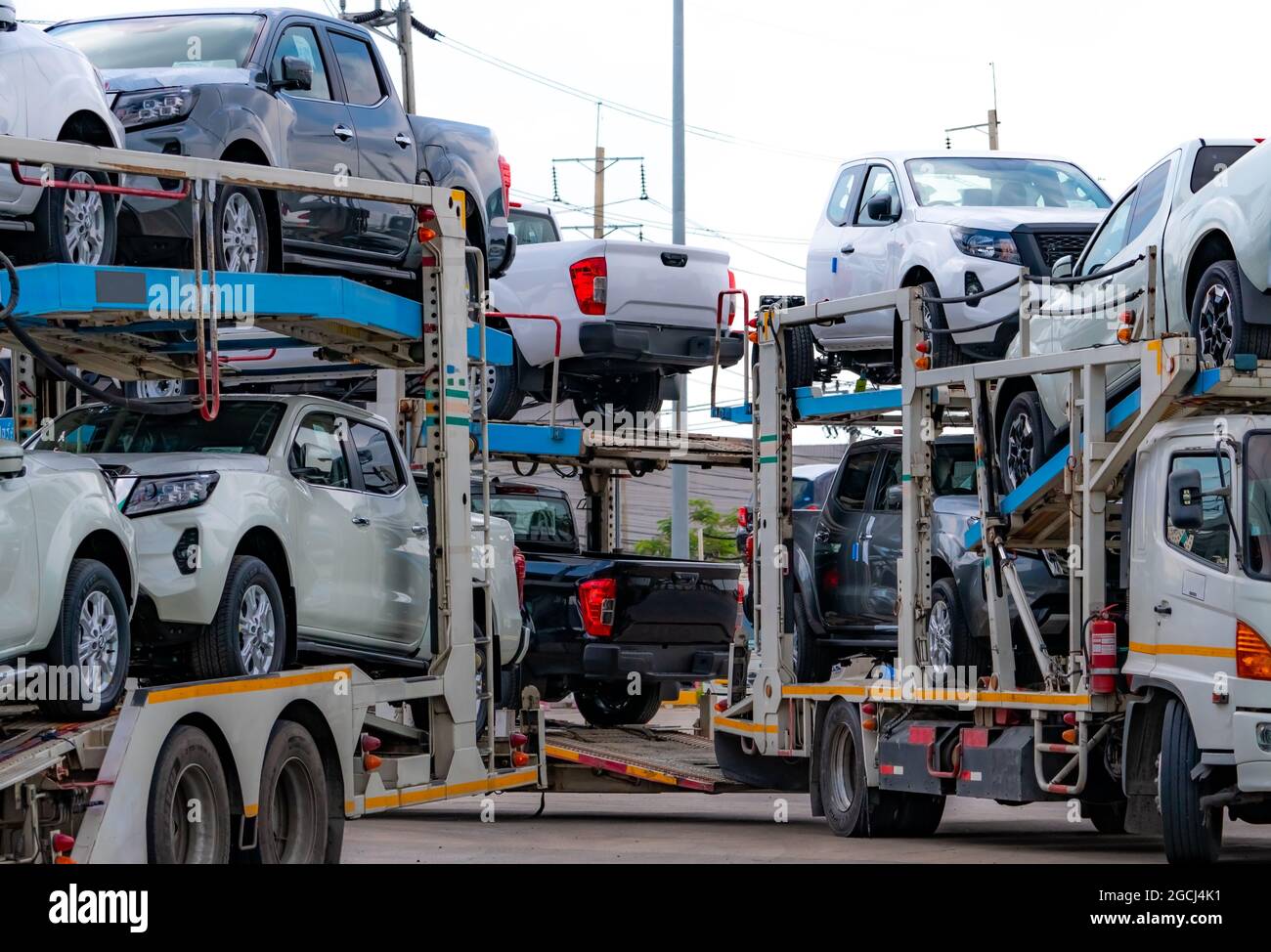 Car carrier trailer transport new car from manufacturing factory to dealer. Auto vehicle haul truck delivery. Transport logistics in automotive Stock Photo