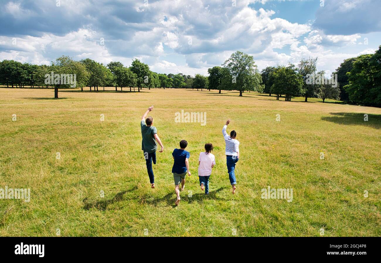 A group of young people are running and in the park. Stock Photo