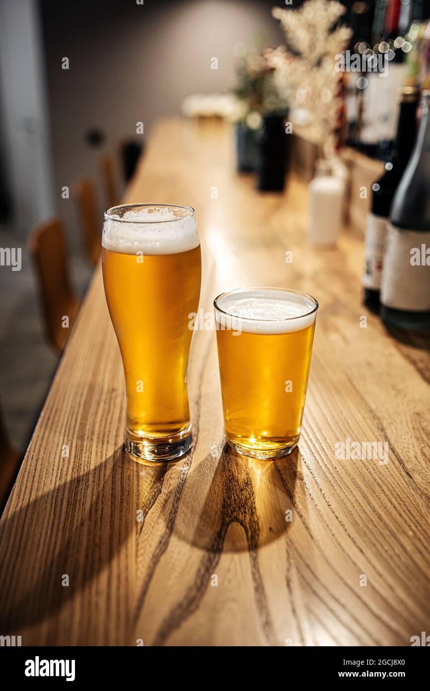 Two glasses of japanese light beer on a bar desk Stock Photo