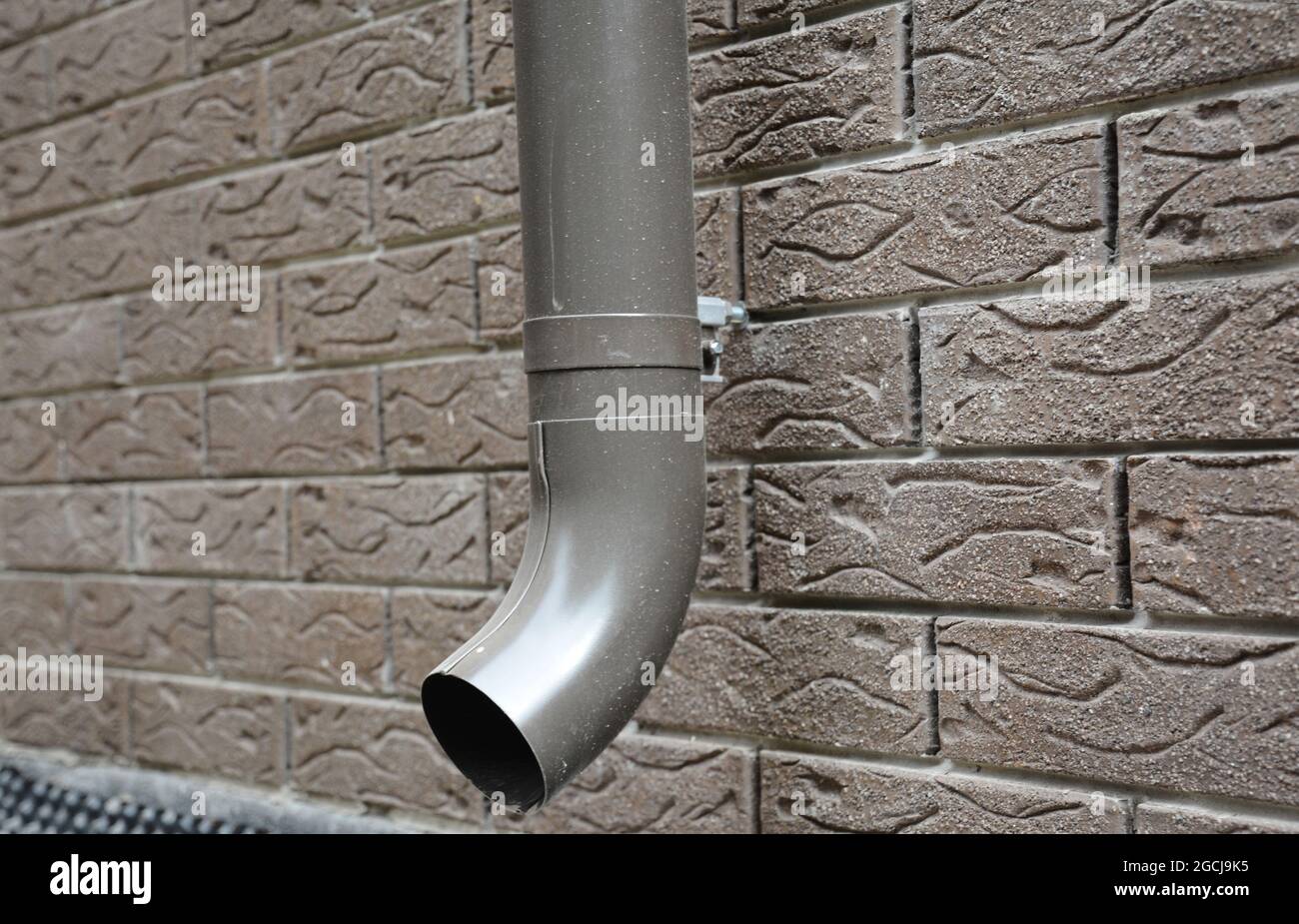 Roof gutter installation a closeup of a metal rain gutter downspout