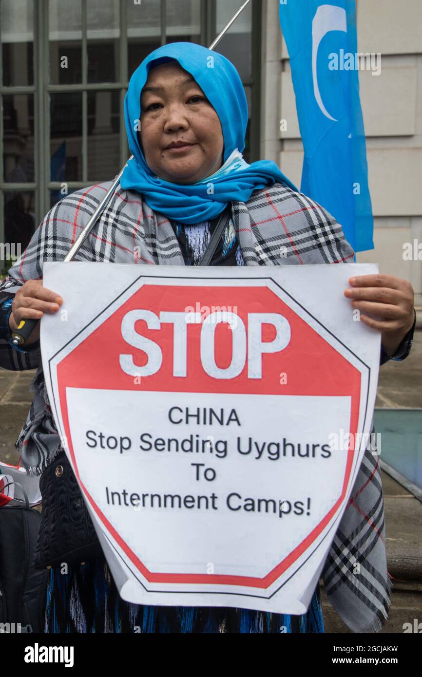 London, UK. 5th August, 2021. A member of the Uyghur community joins activists from Uyghur Solidarity Campaign UK and other supporting groups protesting opposite the Chinese embassy in support of the Uyghur people’s struggle for freedom. Activists highlighted the Chinese government's persecution and forced assimilation of Uyghurs, Kazakhs and other indigenous people in East Turkestan and Xinjiang and called for them to have the right to determine their own futures through a democratic process. Credit: Mark Kerrison/Alamy Live News Stock Photo