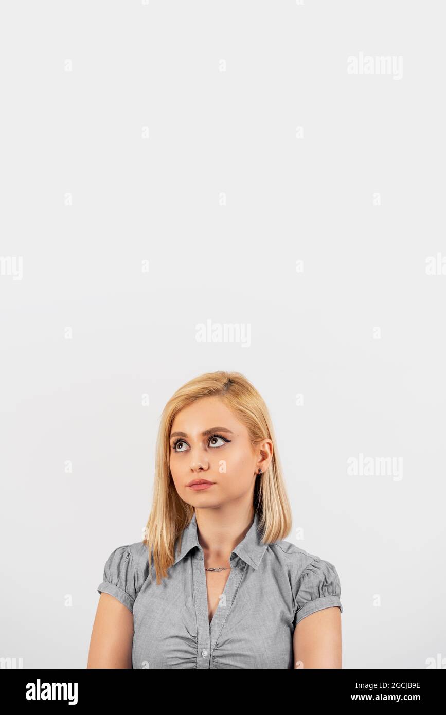 Sad and depressed young blonde woman is looking, Isolated on white background. High quality photo Stock Photo
