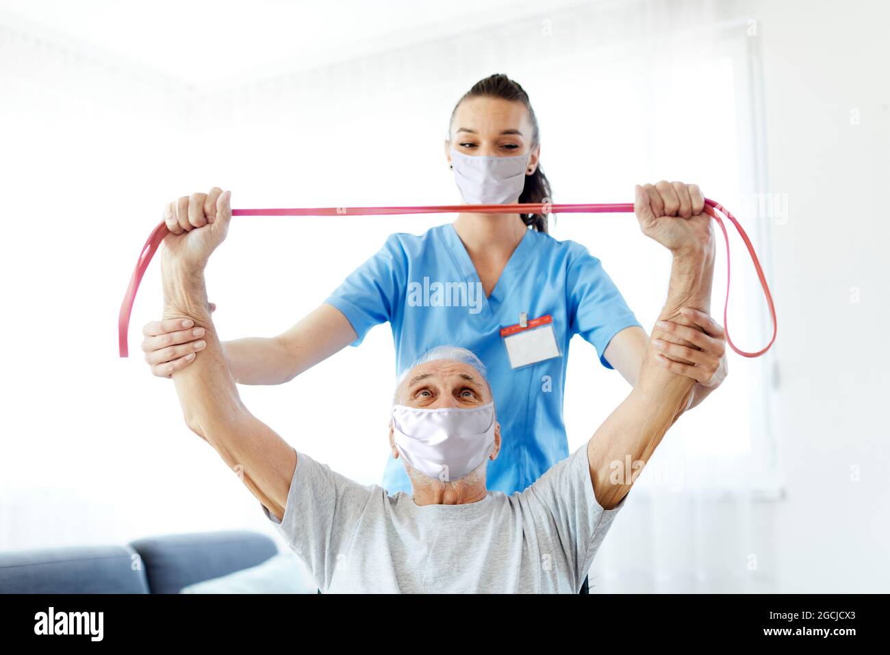 nurse doctor senior care exercise physical therapy ecercising help assistence retirement mask virus corona Stock Photo