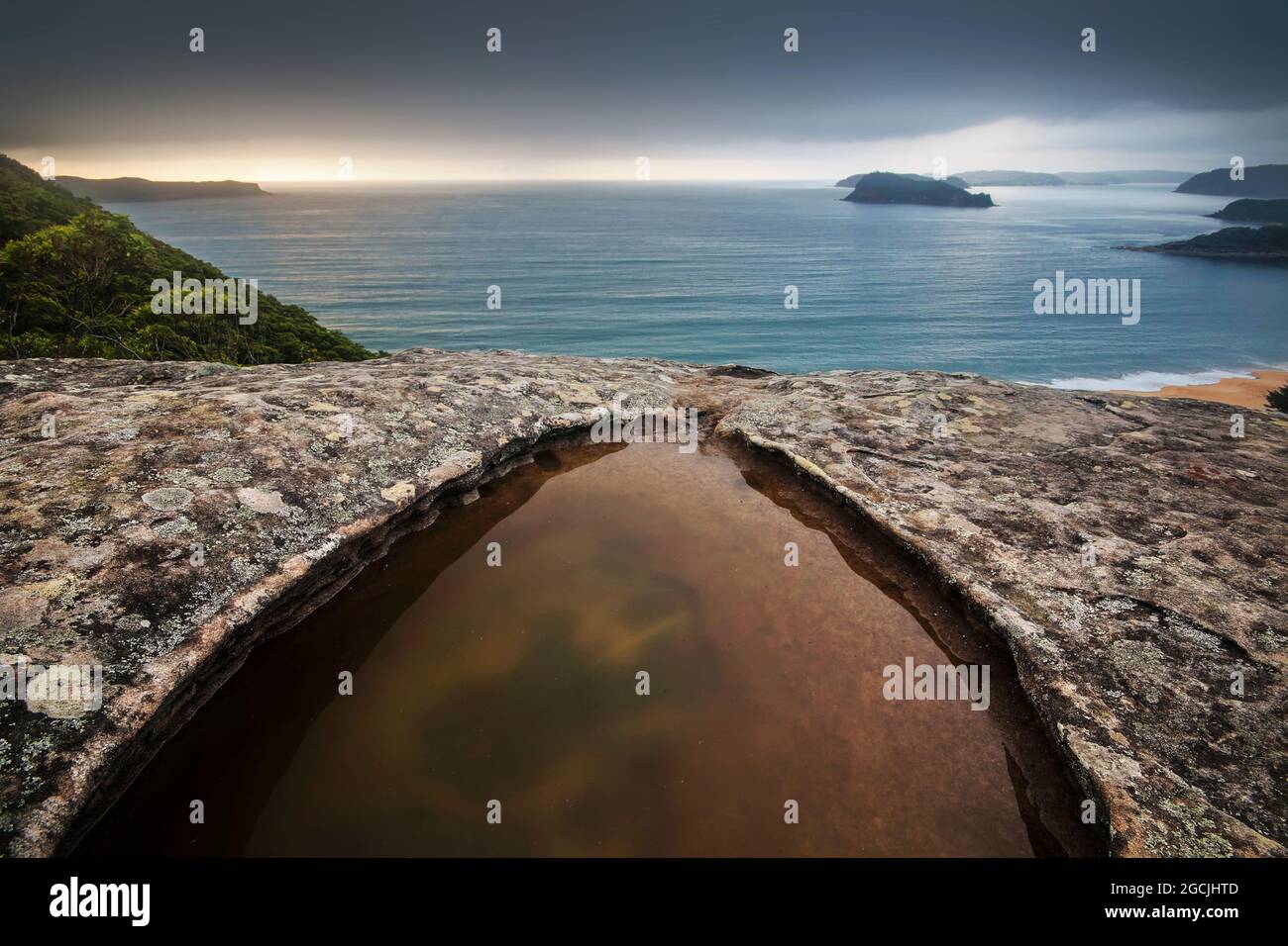 a puddle on a mountain overlooking pearl beach Stock Photo