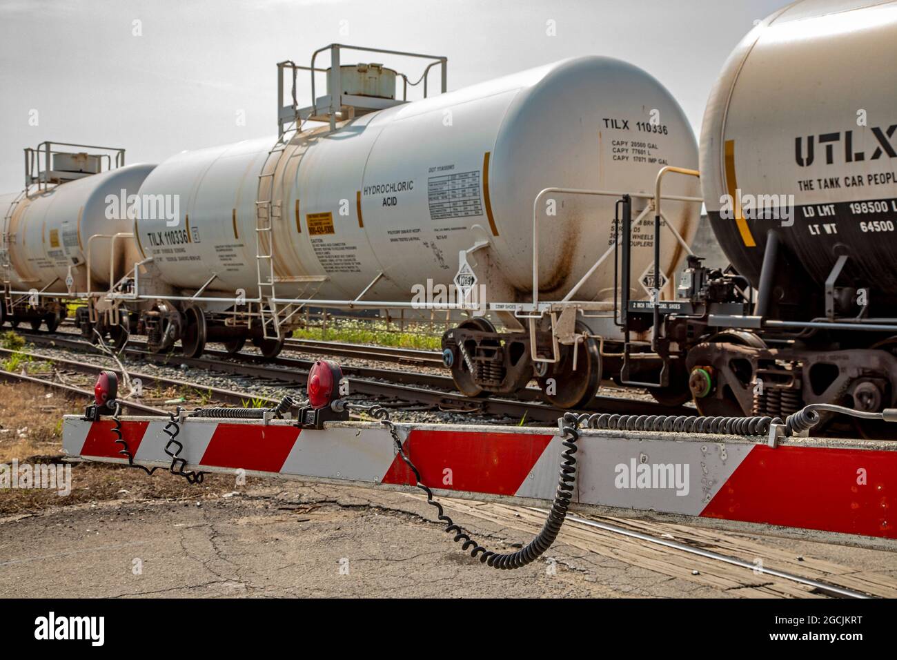 Detroit, Michigan - A railroad chemical tank car containing hydrochloric acid passes a street crossing near downtown Detroit. Stock Photo
