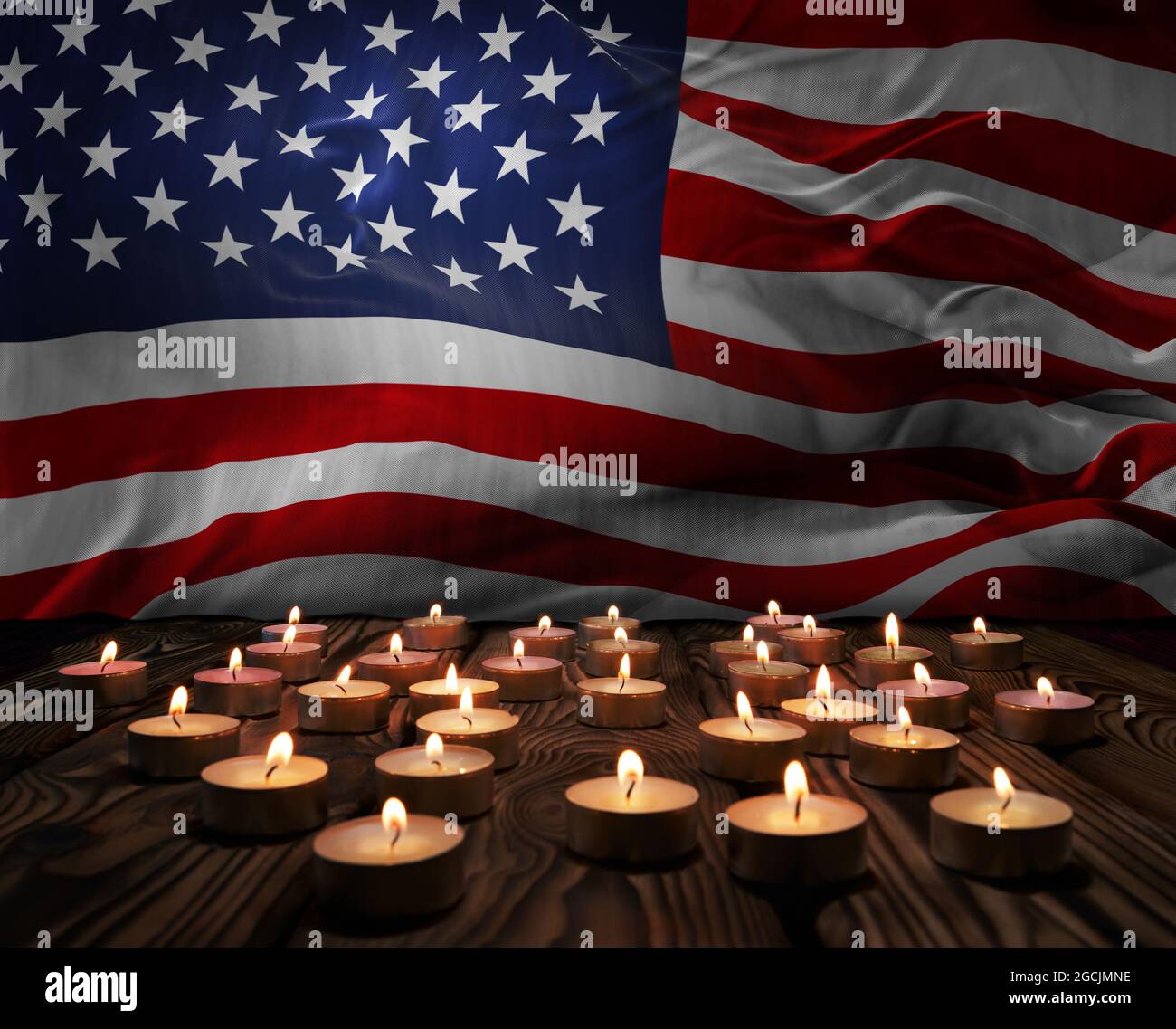 Mourning candles burning on USA national flag of background. Memorial