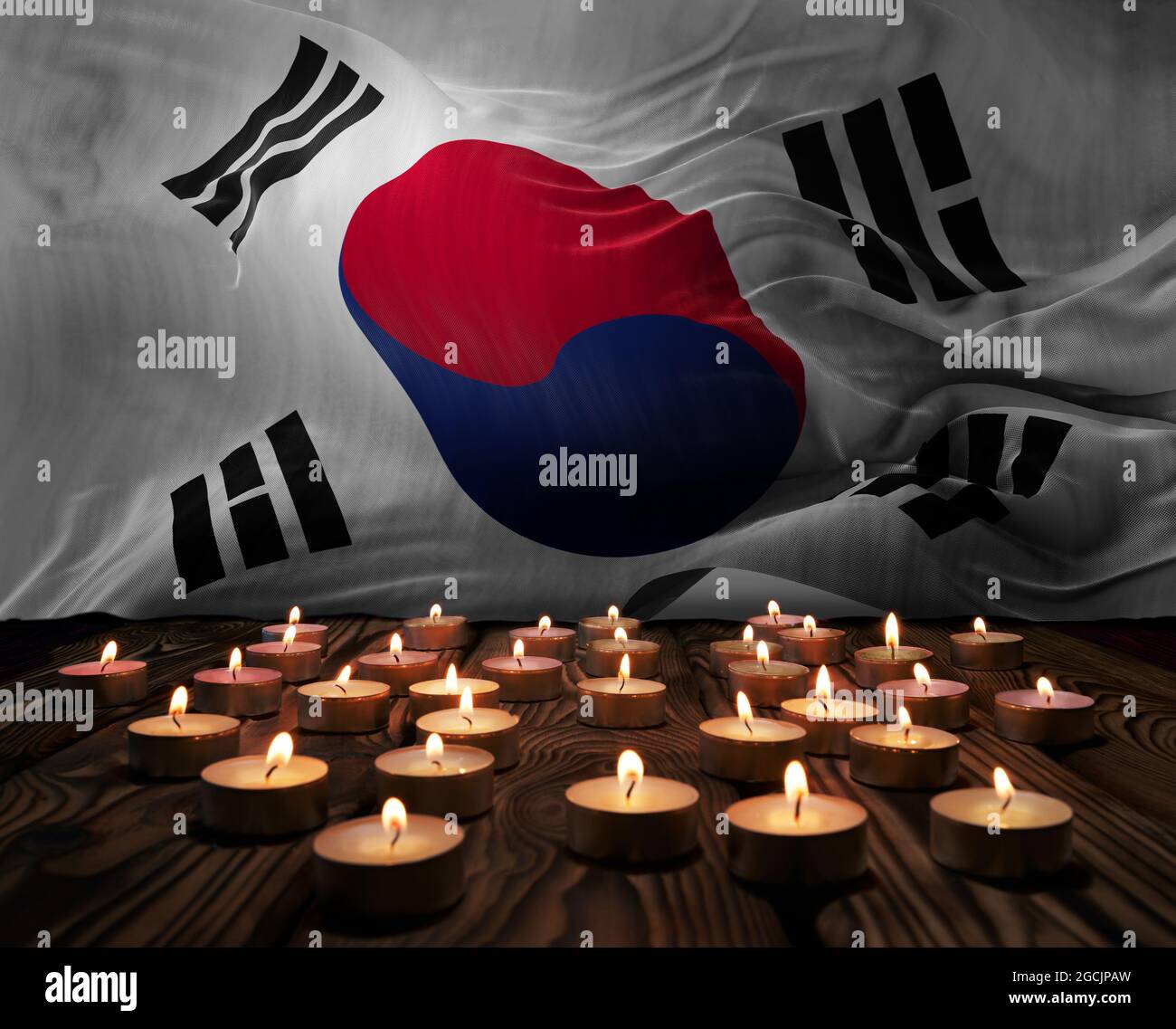 Mourning candles burning on South korea national flag of background. Memorial weekend, patriot veterans day, National Day of Service Remembrance. Burn Stock Photo