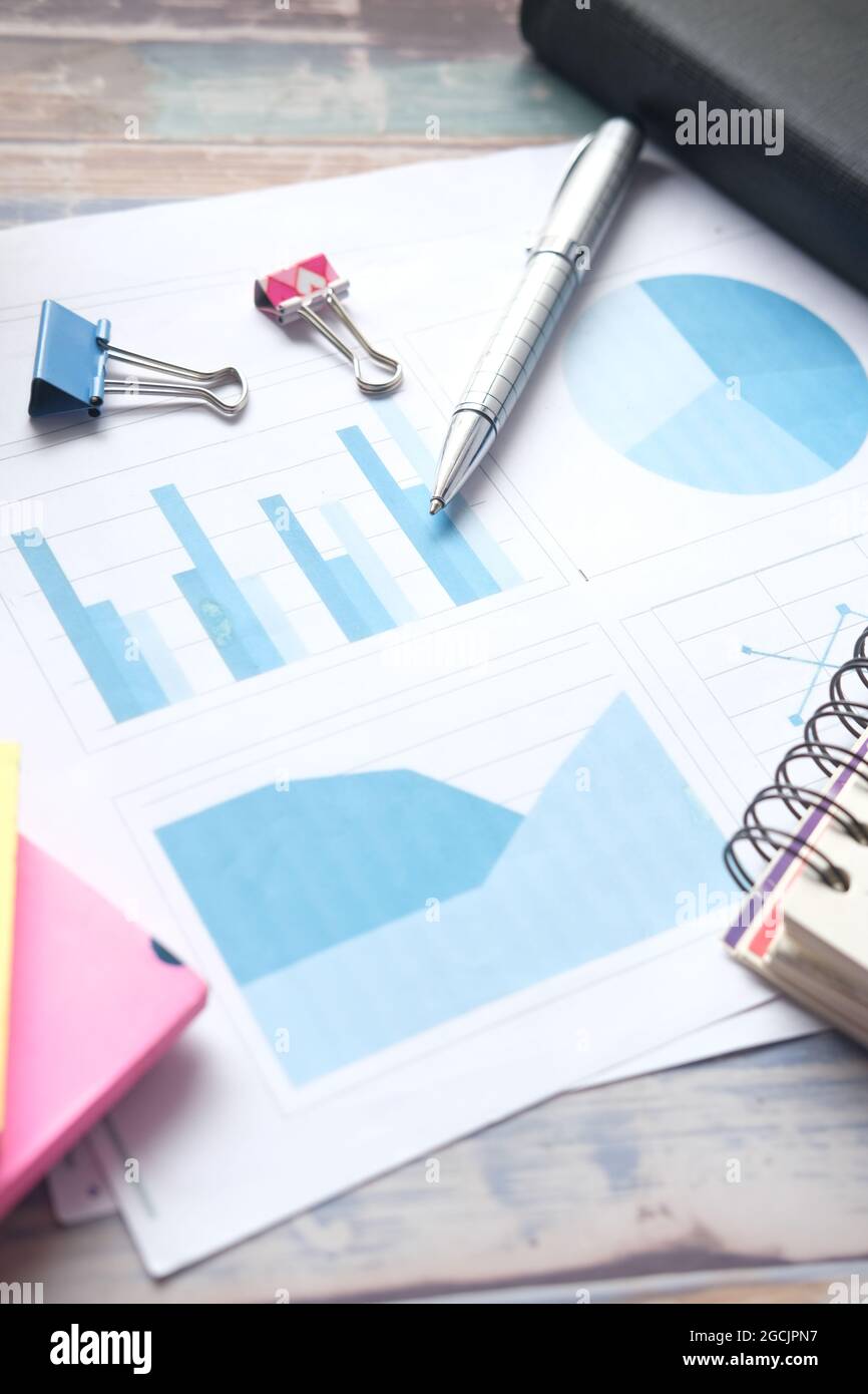 financial graph, calculator and notepad on table Stock Photo - Alamy