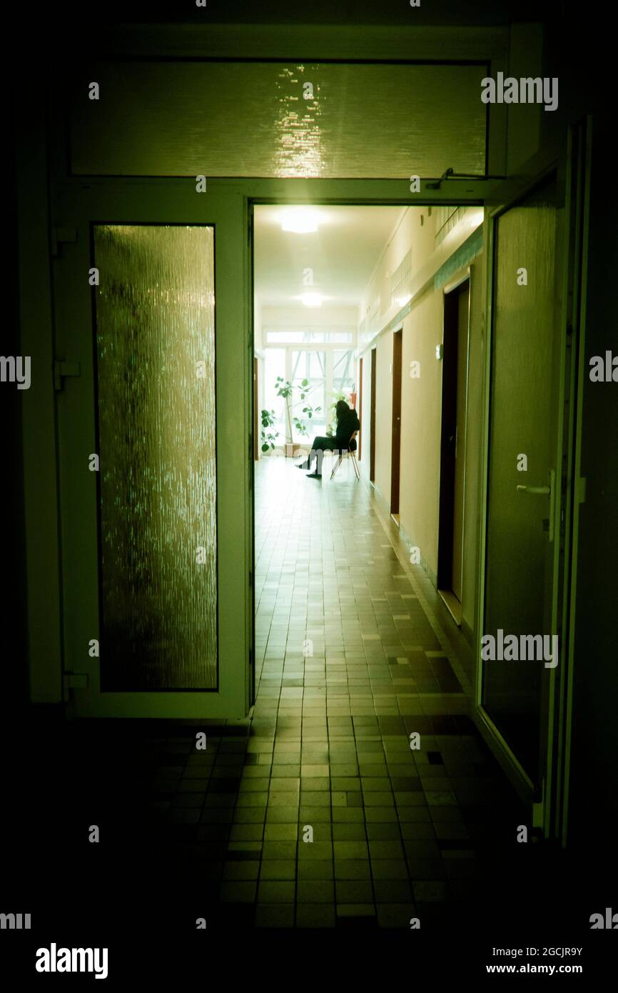 blurred woman sitting in an hospital corridor Stock Photo