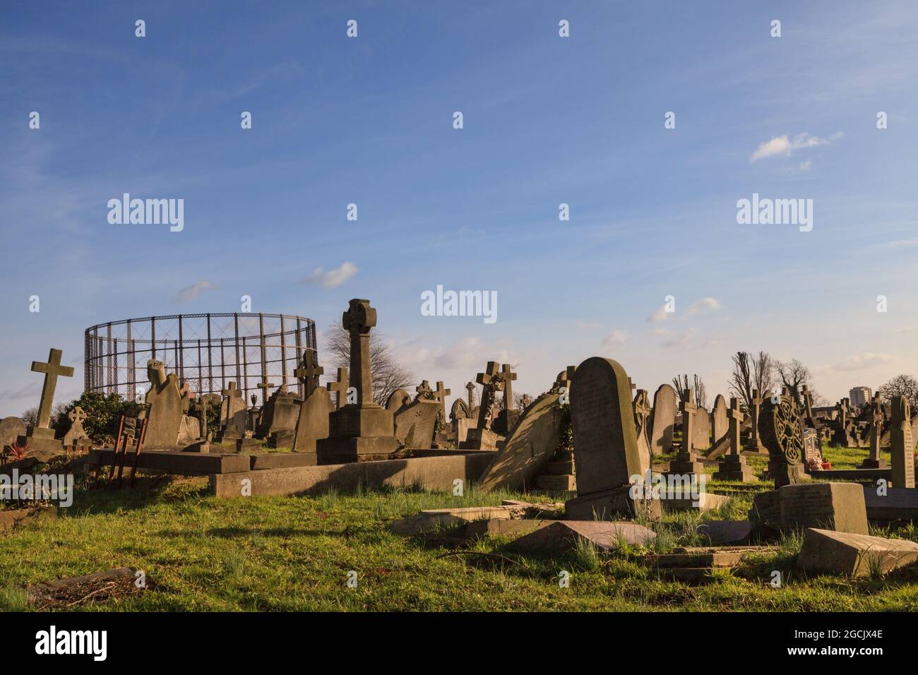 Gravestones and gasometer, Kensal Green Cemetery and graveyard, Kensington, London, England Stock Photo