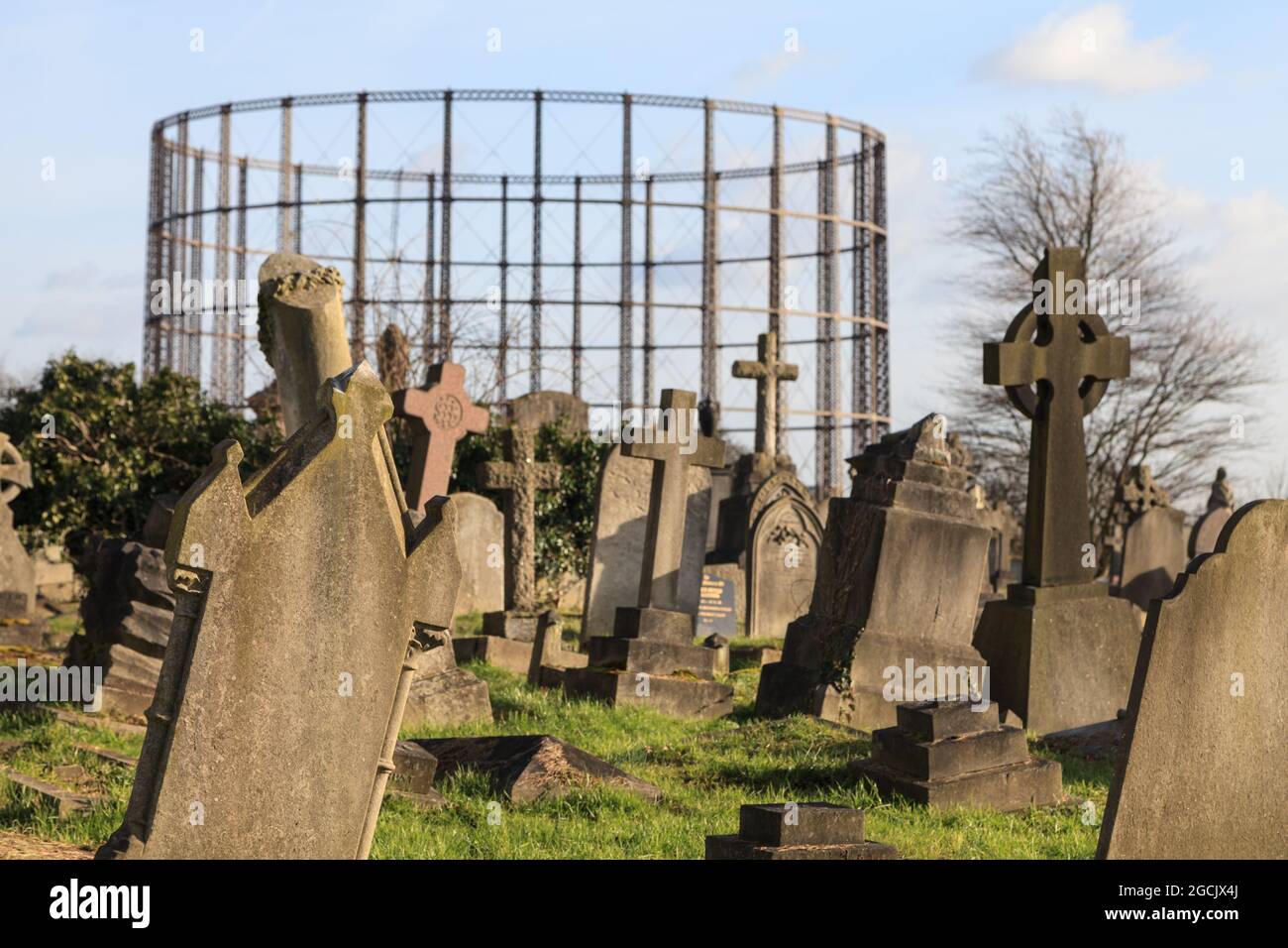 Gravestones and gasometer, Kensal Green Cemetery and graveyard, Kensington, London, England Stock Photo