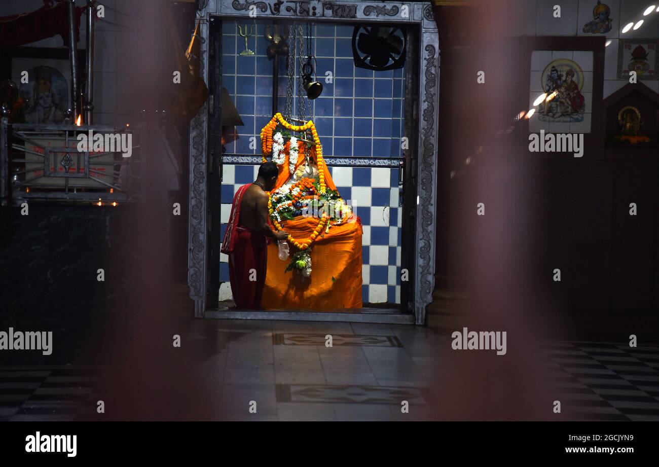 Guwahati, Guwahati, India. 9th Aug, 2021. A Hindu priest perform ritual on Siva Linga during the holy month of Shravan at Sukleswar temple in Guwahati, Assam India on Monday 9th August 2021 (Credit Image: © Dasarath Deka/ZUMA Press Wire) Stock Photo