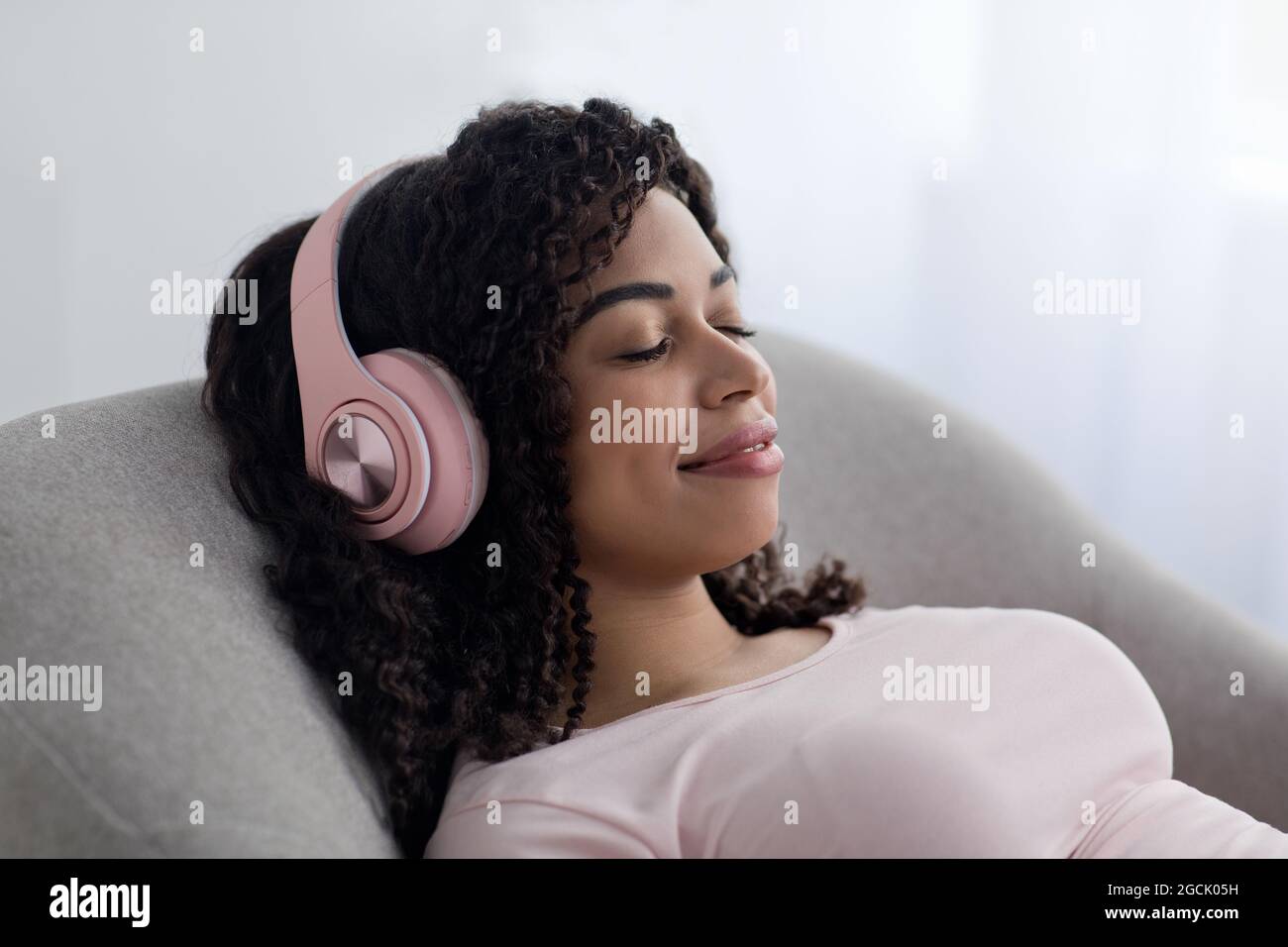 Peace of mind, listen favorite music, enjoy modern technology at home at spare time Stock Photo