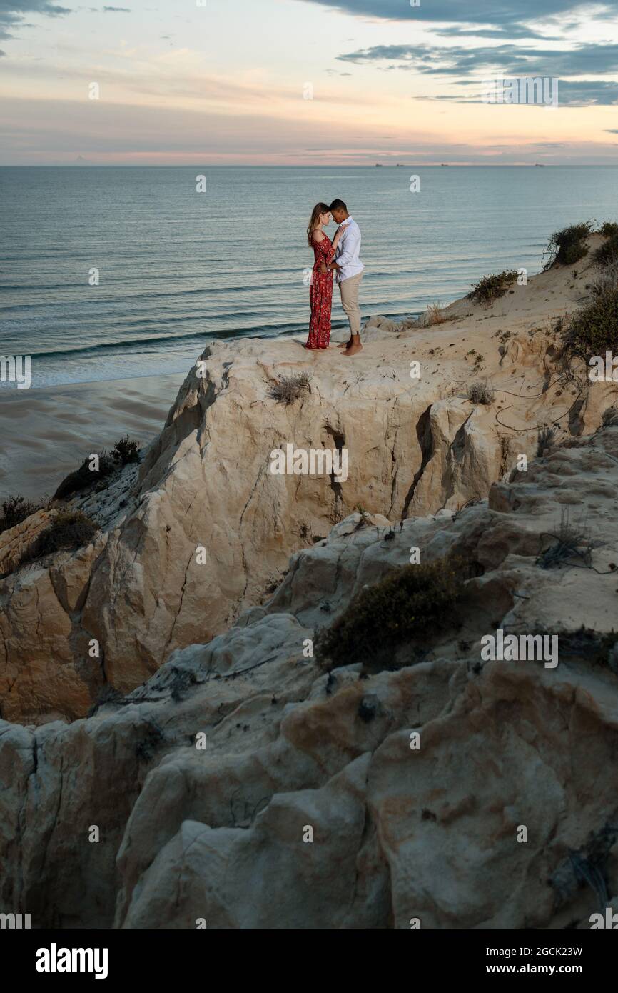 Couple embrace on hill sunset hi-res stock photography and images - Alamy