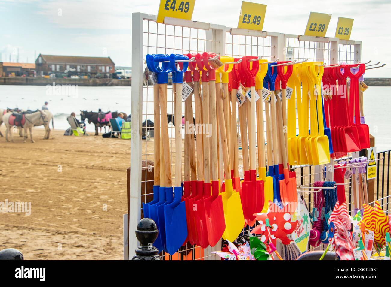 children's colourful plastic bucket and spades and beach toys in