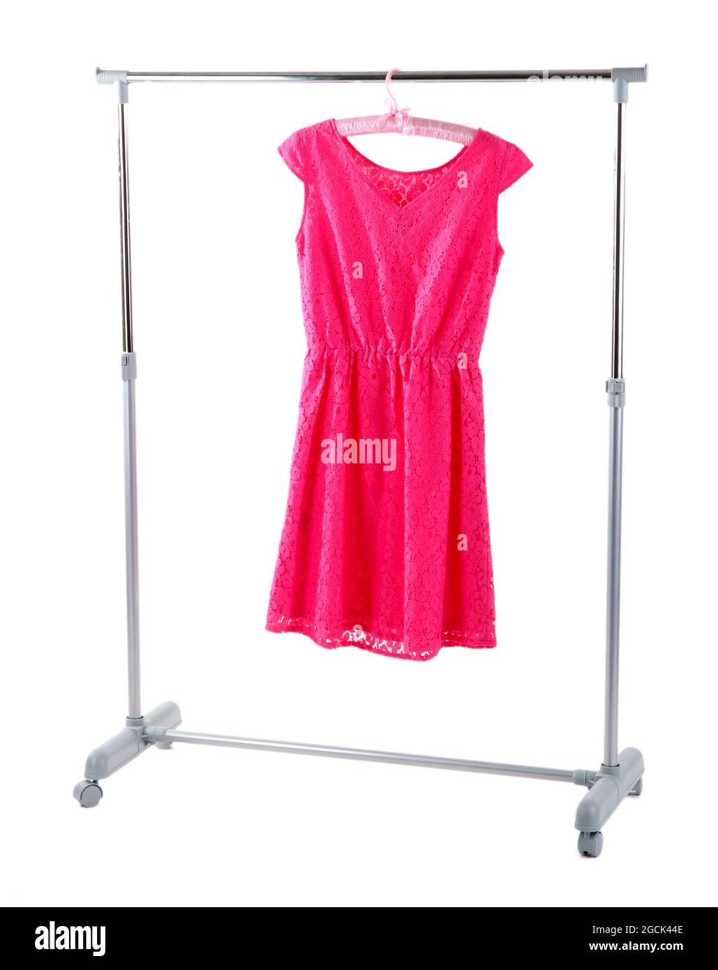 Beautiful pink dress hanging on hangers isolated on white Stock Photo