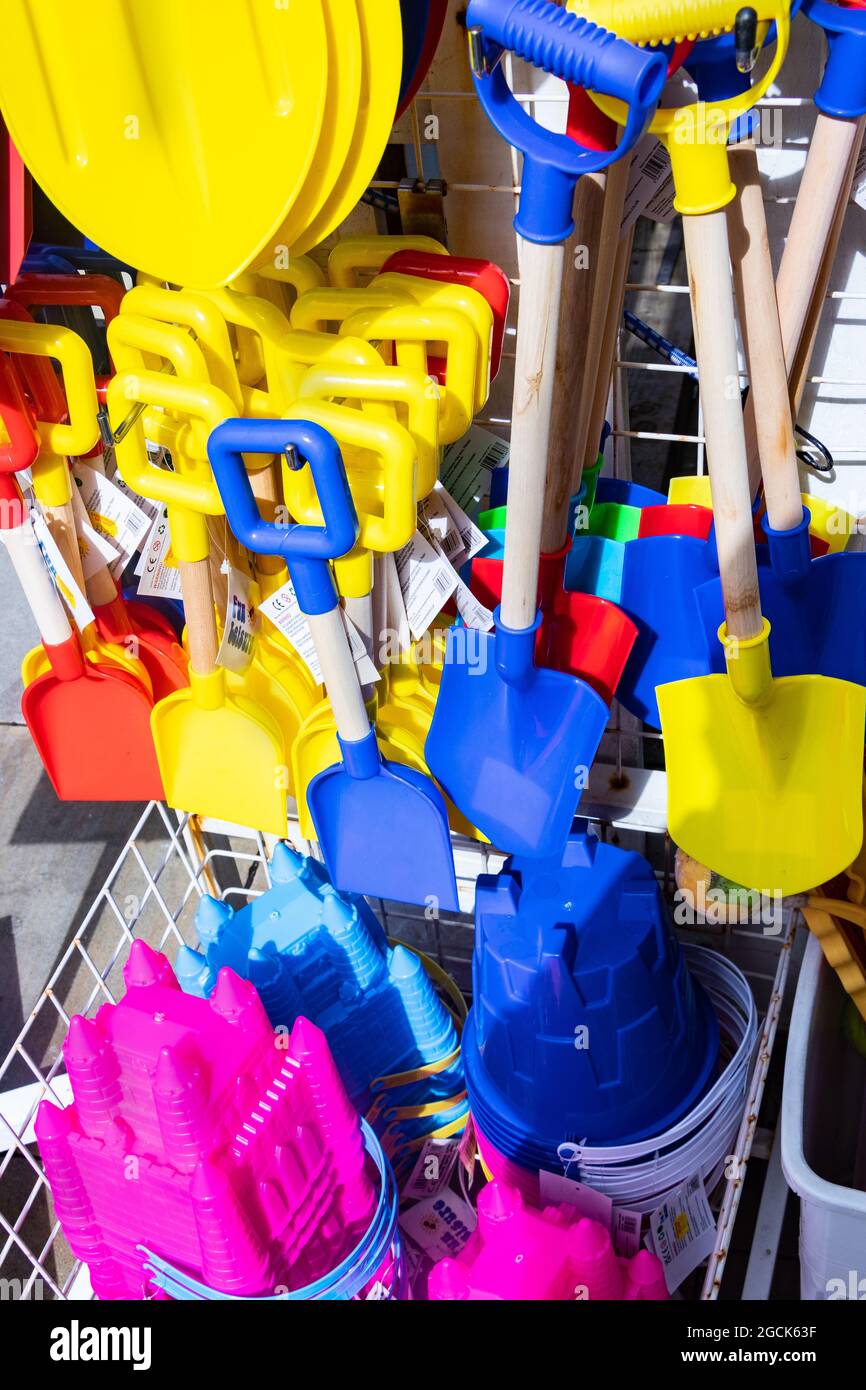 children's colourful plastic bucket and spades and beach toys in