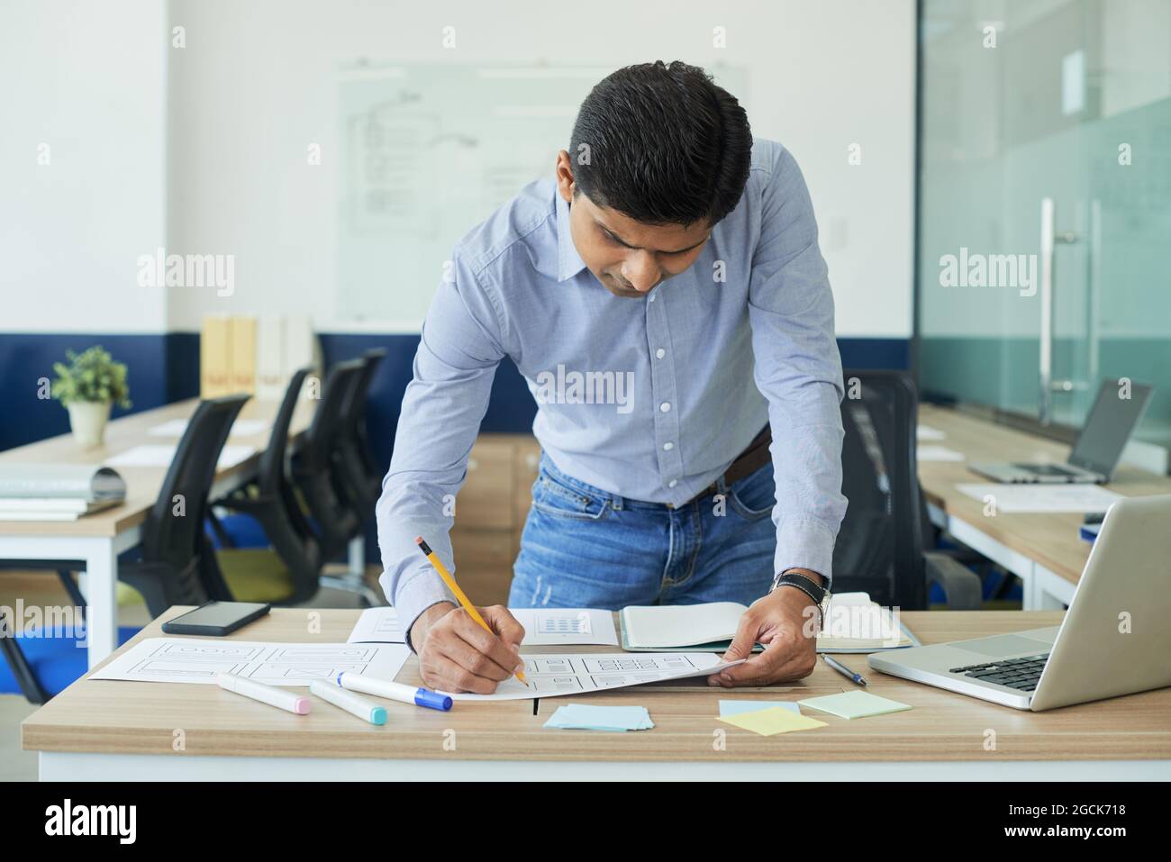UI designer making corrections in final version of new mobile app interface Stock Photo
