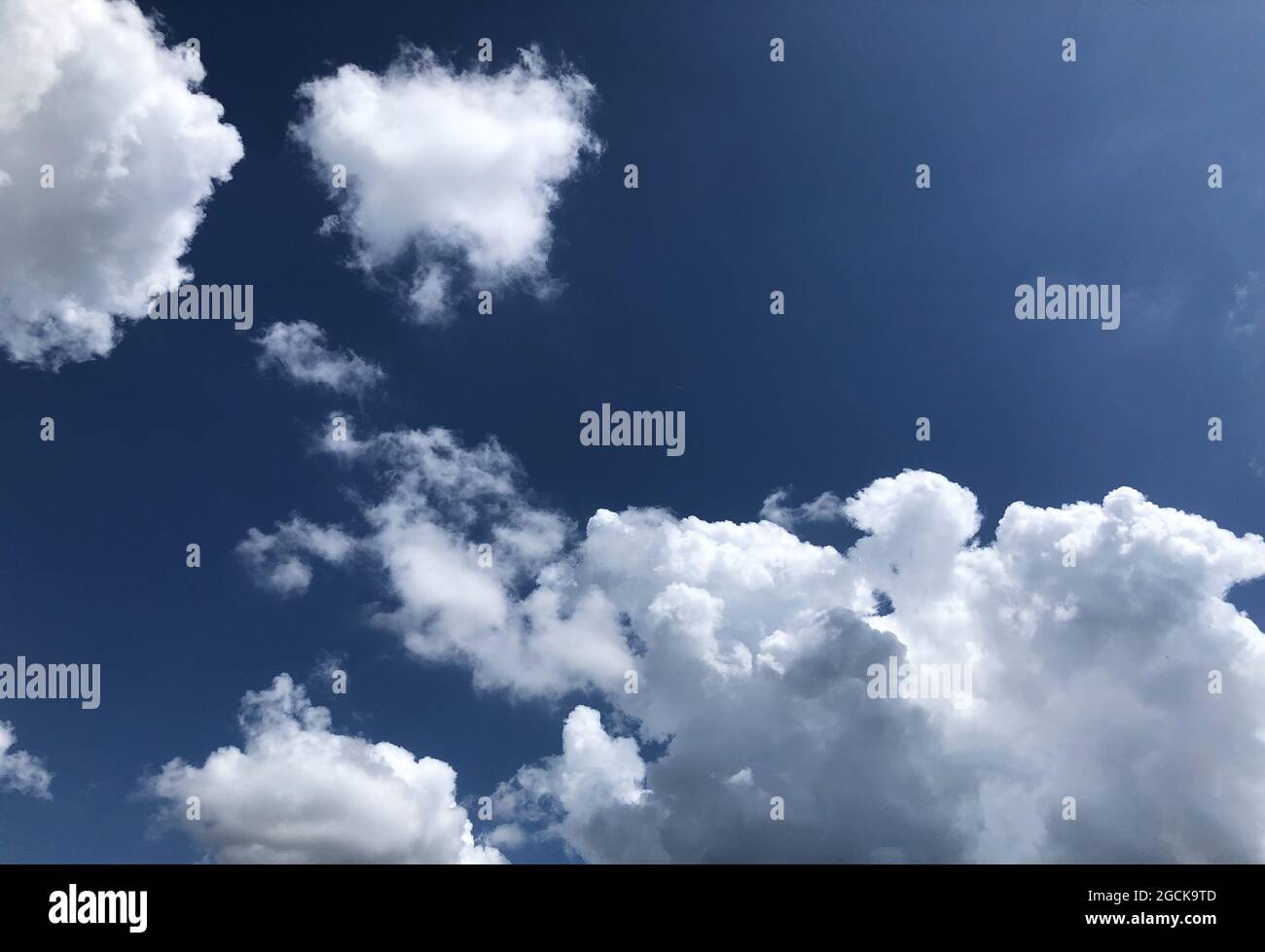 Beautiful cloudscape in a clear blue sky Stock Photo - Alamy