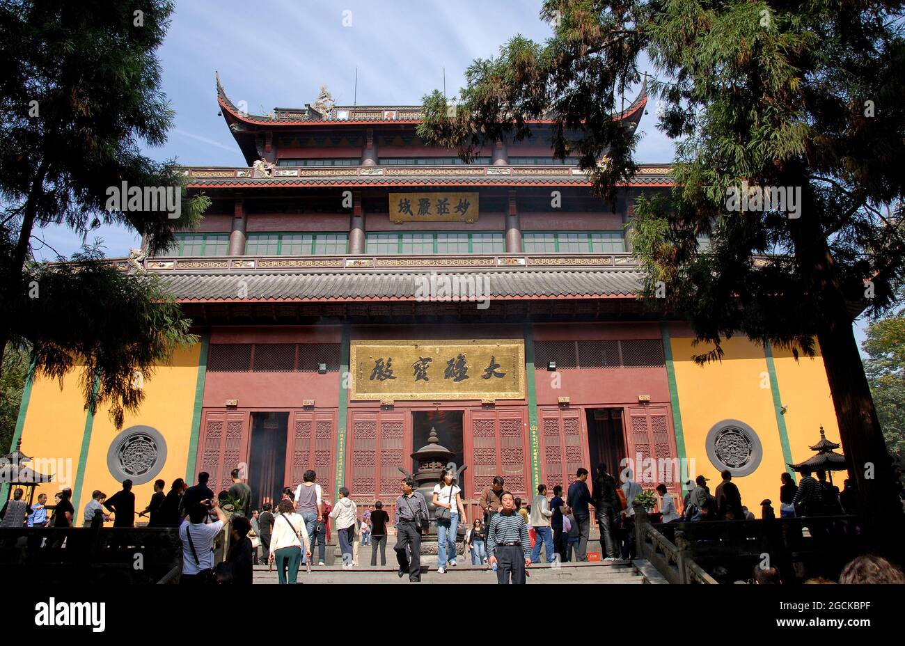 Lingyin Temple also known as the Temple of the Soul's Retreat in Hangzhou, China. View of the Maravira Hall the main hall of the temple with people. Stock Photo
