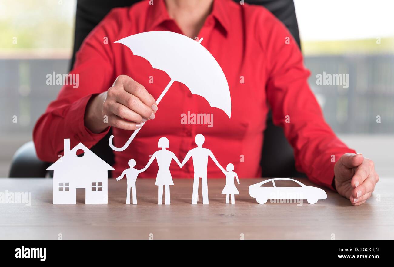 Insurer protecting a house, a family and a car Stock Photo