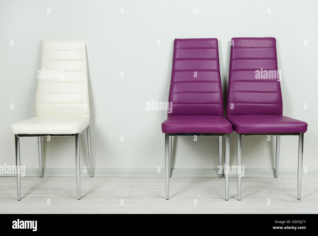 Modern color chairs on wall background Stock Photo Alamy