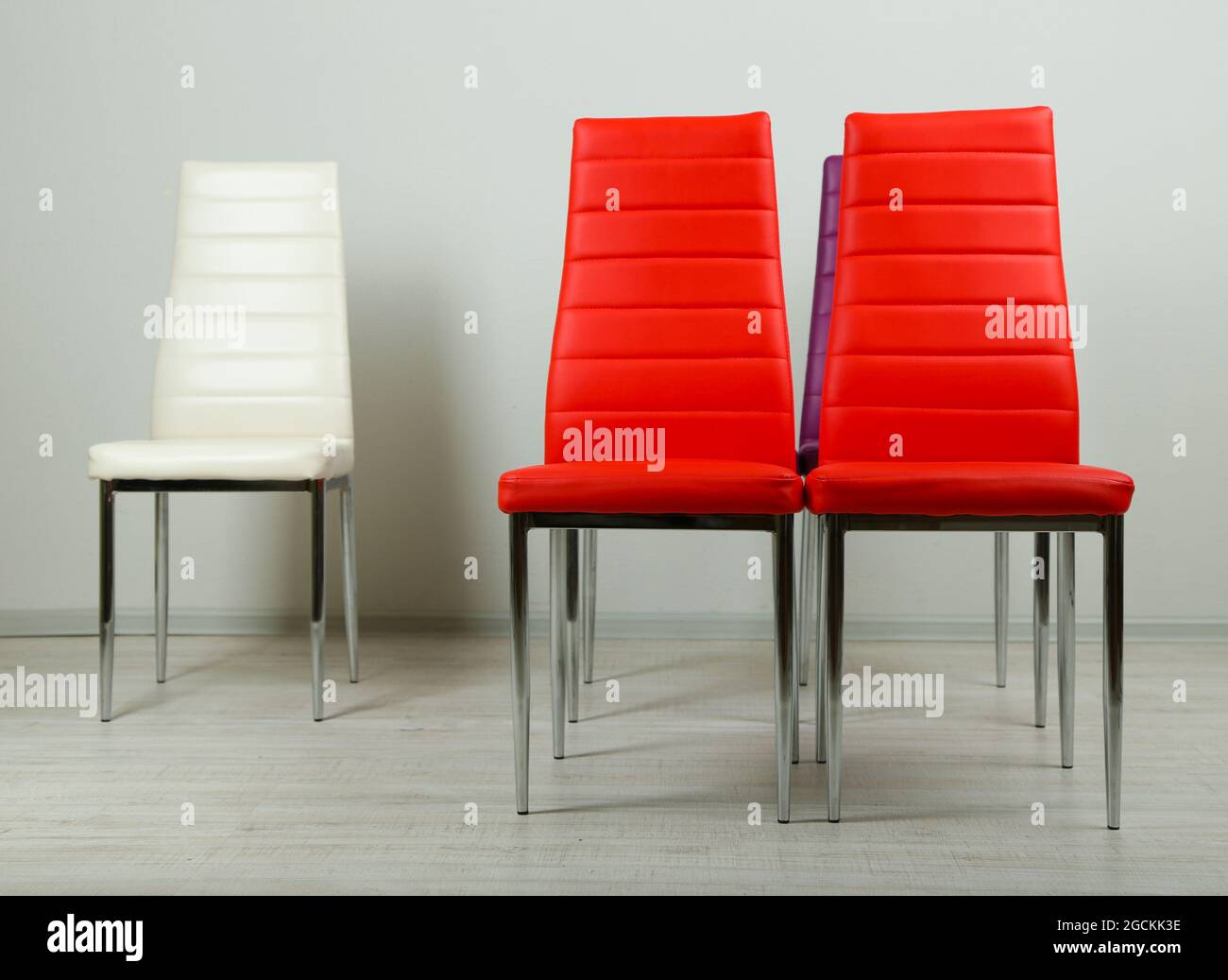 Modern color chairs on wall background Stock Photo Alamy