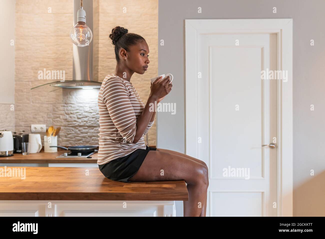 African woman sitting alone side view hi-res stock photography and ...