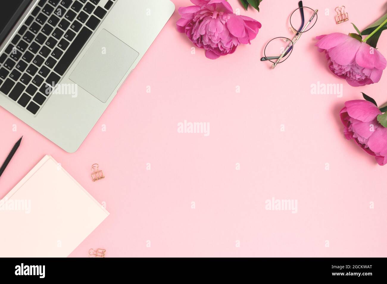 Cute workspace with laptop, stationery and flowers on a pink pastel  background. Work from home concept with copy space Stock Photo - Alamy