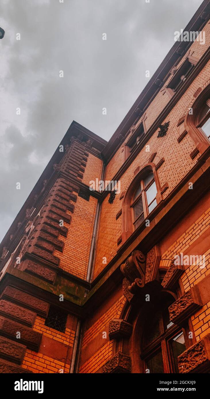 Low-angle shot of an old building with a brick facade against the ...