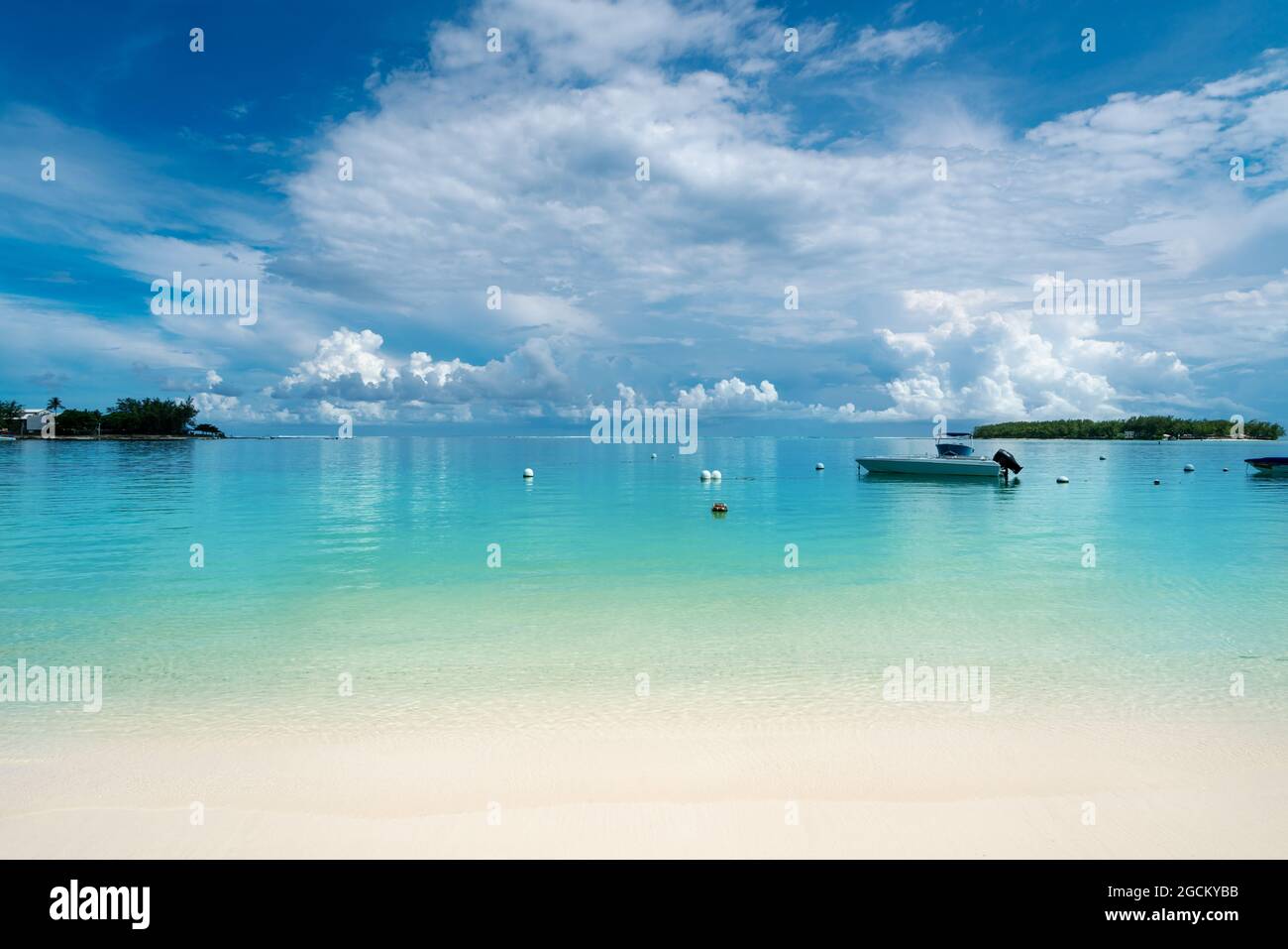 Idyllic tropical tourist destination on the Blue Bay beach with blue sea water in the summertime - Mauritius Stock Photo