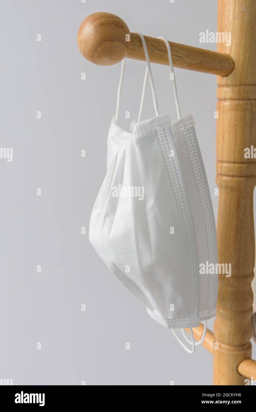 Medical white masks hanging on a wooden hanger Stock Photo Alamy