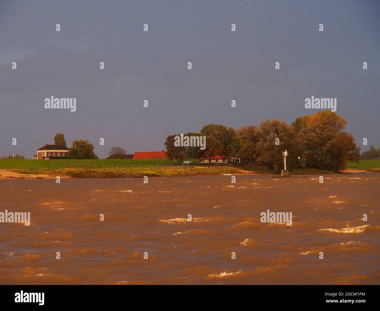 Dramatic orange sky turns River Rhine and surrounding area orange Stock Photo