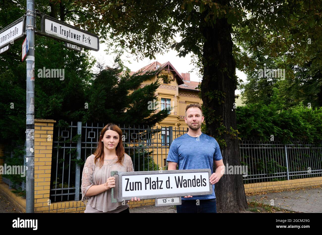 Berlin, Germany. 09th Aug, 2021. Ana-Maria Trasnea, SPD candidate for the Bundestag, and Alexander Freier-Winterwerb, SPD candidate for the House of Representatives for the districts of Alt-Treptow, Plänterwald and Baumschulenweg, hold a street sign reading 'To the Square of Change' in front of the Embassy of the Republic of Belarus. Symbolic of the anniversary of the disputed presidential election in Belarus, they call the street 'Am Treptower Park'. Credit: Annette Riedl/dpa/Alamy Live News Stock Photo