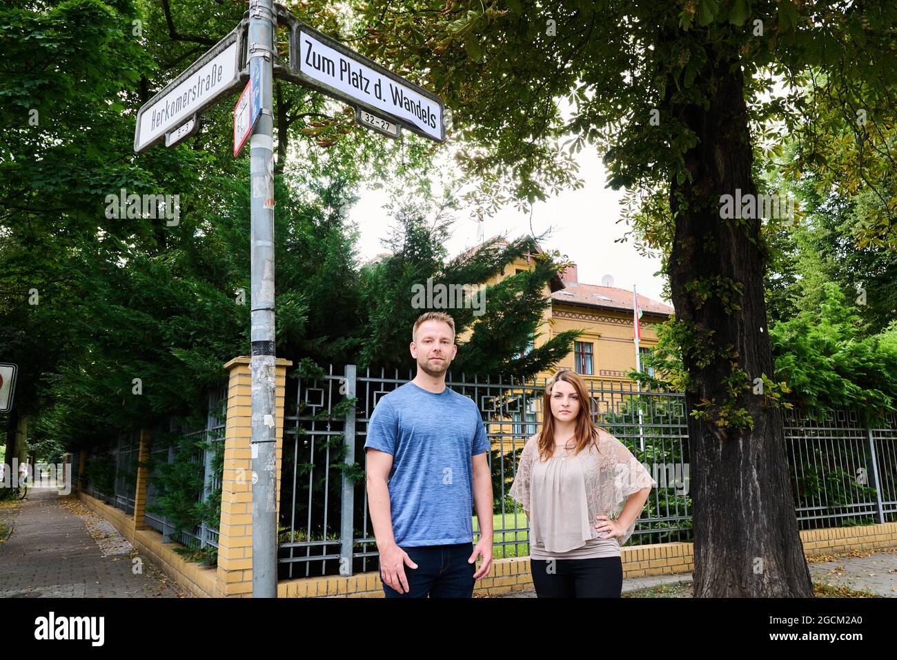 Berlin, Germany. 09th Aug, 2021. Ana-Maria Trasnea, SPD candidate for the Bundestag, and Alexander Freier-Winterwerb, SPD candidate for the House of Representatives for the districts of Alt-Treptow, Plänterwald and Baumschulenweg, stand under a street sign reading 'Zum Platz des Wandels' in front of the Embassy of the Republic of Belarus. Symbolically on the anniversary of the disputed presidential election in Belarus, they renamed the street 'Am Treptower Park' to 'Zum Platz des Wandels'. Credit: Annette Riedl/dpa/Alamy Live News Stock Photo