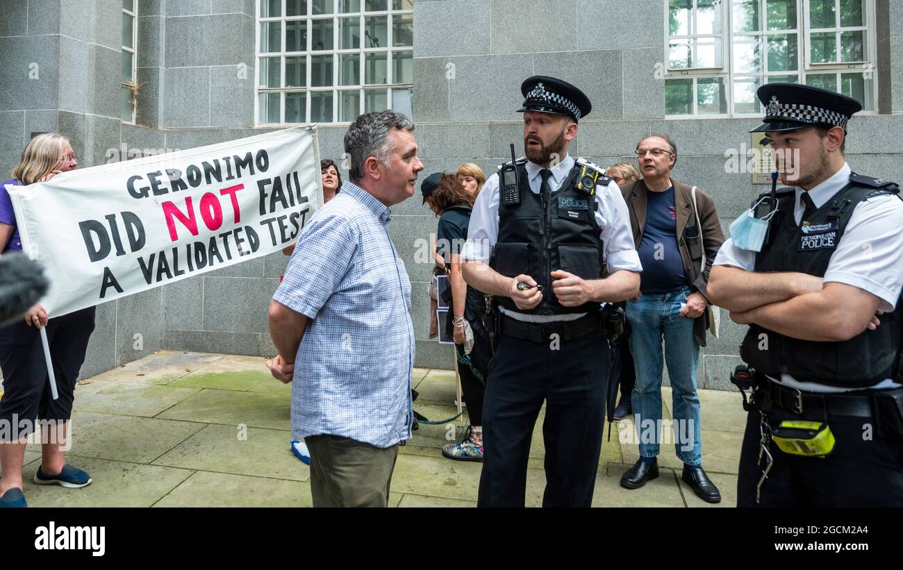 London, UK.  9 August 2021.  Dominic Dyer (C) of Born Free Foundation speaks to police officers outside the Department for Environment, Food and Rural Affairs (DEFRA) campaigning to save the life Geronimo the alpaca after Environment Secretary George Eustice defended a controversial decision to put down the animal that has twice tested positive for bovine tuberculosis.  Geronimo's owner, veterinary nurse Helen Macdonald, who breeds alpacas at her farm in Wickwar, south Gloucestershire, claims the tests used were inaccurate and wants Geronimo to receive a more accurate Actiphage test. Credit: S Stock Photo