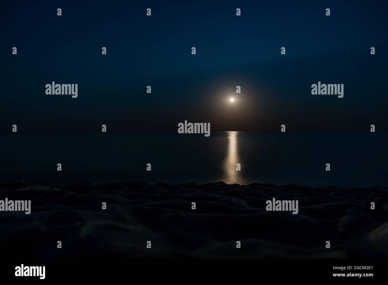 Moonlit path on the night sea. Summer coast. Beautiful landscape. Full moon Stock Photo