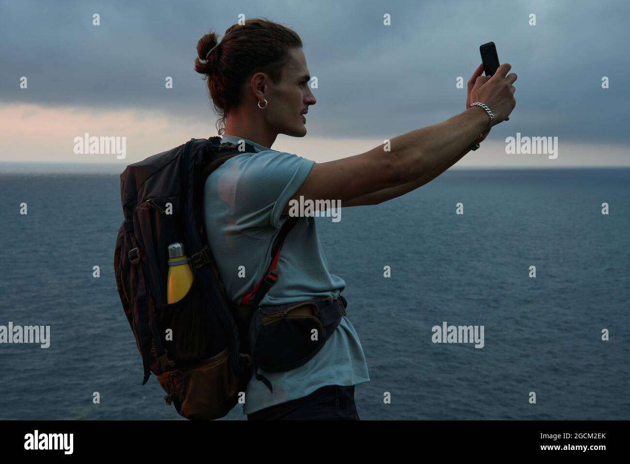 Anonymous astonished ethnic female with open mouth exploring virtual reality in headset on black background Stock Photo