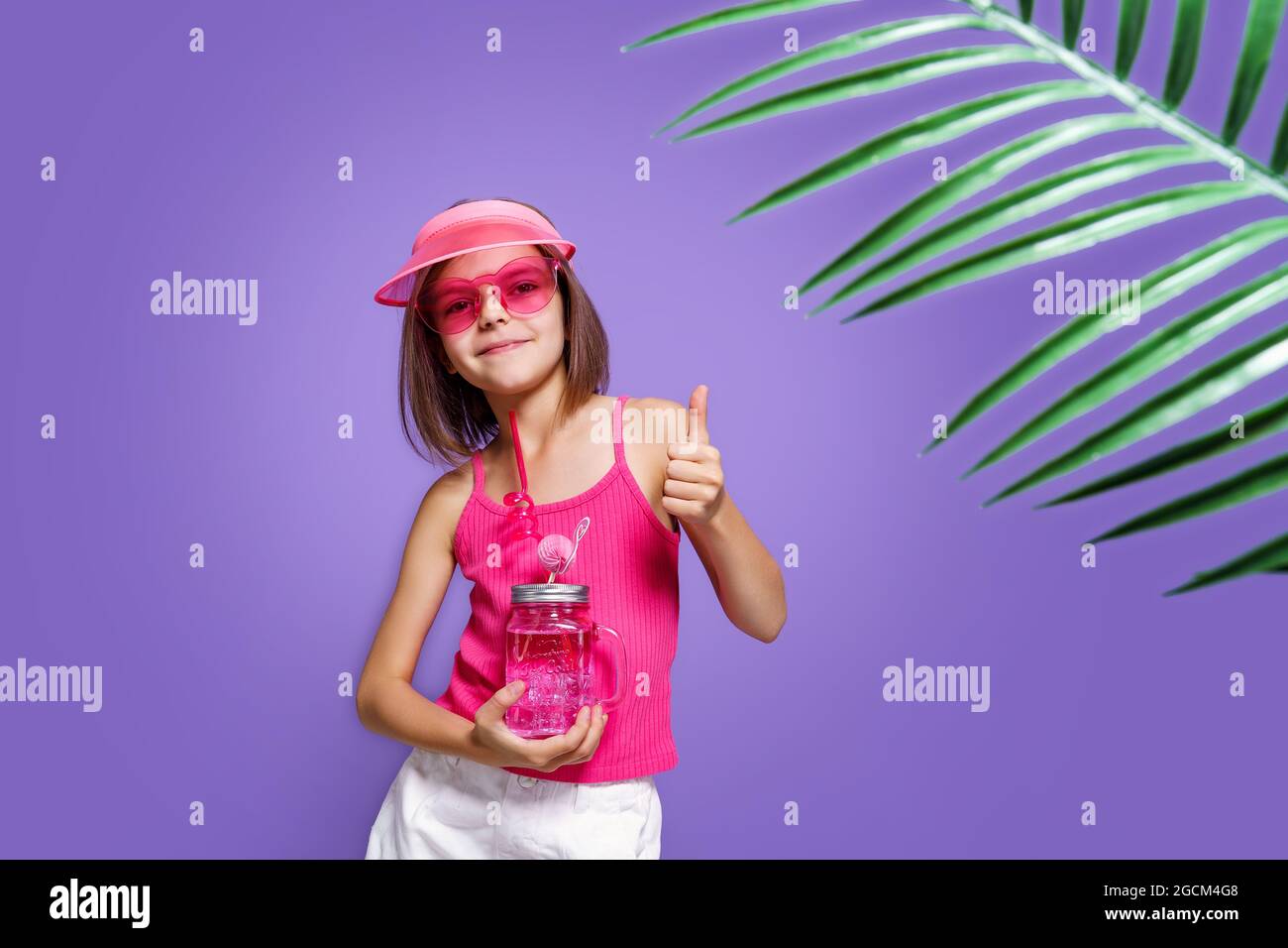 Back view of little child girl in white t-shirt, jeans shorts and pink  sneakers posing near the wall Stock Photo - Alamy