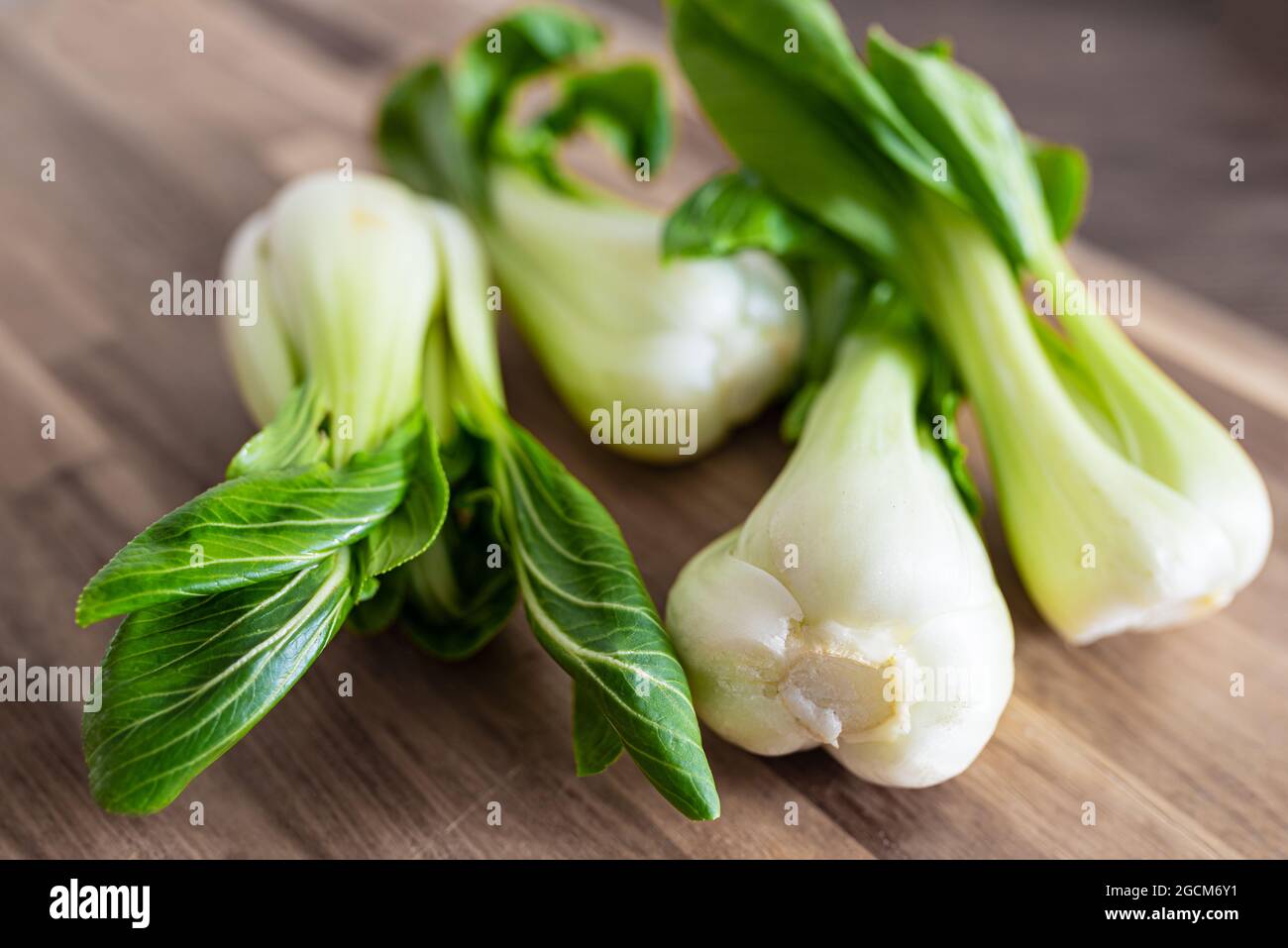 high angle view of fresh Bok Choy, chinese cabbage, on wooden cutting board Stock Photo