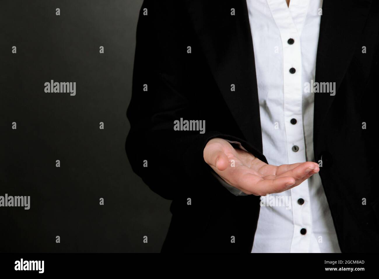 Female hands showing something on grey background Stock Photo - Alamy