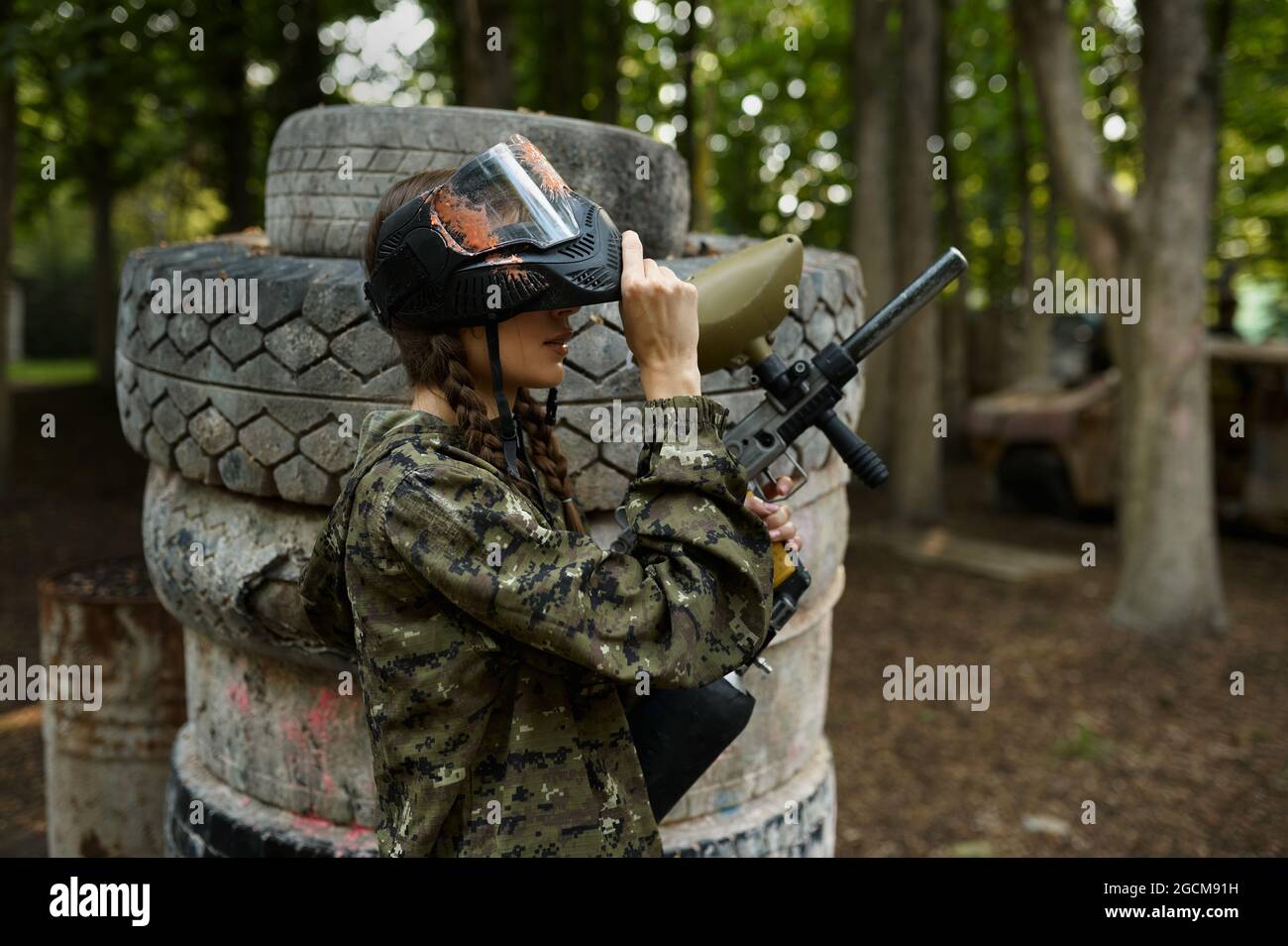 Female paintball player on playground in forest Stock Photo Alamy