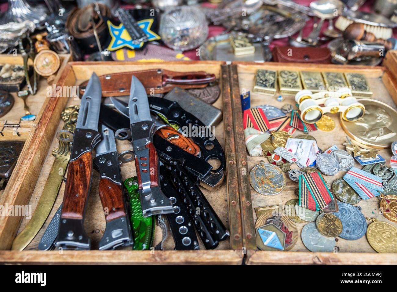 Soviet era medal and insignia, pocket knives and daggers on the flea market in the Plac Nowy in Krakow, Poland Stock Photo